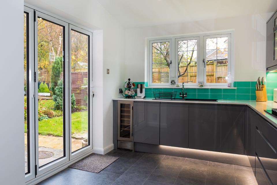Looking out the rear kitchen window and patio door in a newly built rear extension.