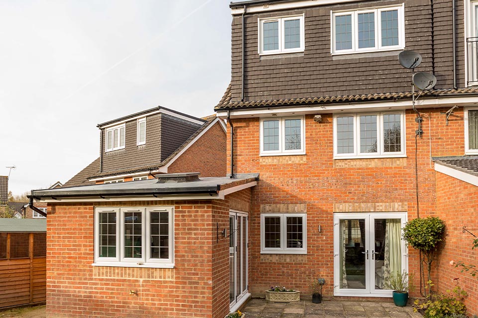 A semi-detatched suburban house with a new rear extension and rear loft conversion.