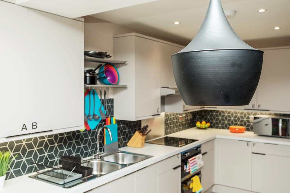 A newly installed kitchen in a communal living space of a multiple occupancy house.