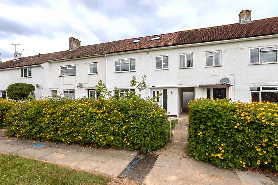 Exterior shot of a terrace building with a recent architectural changes.