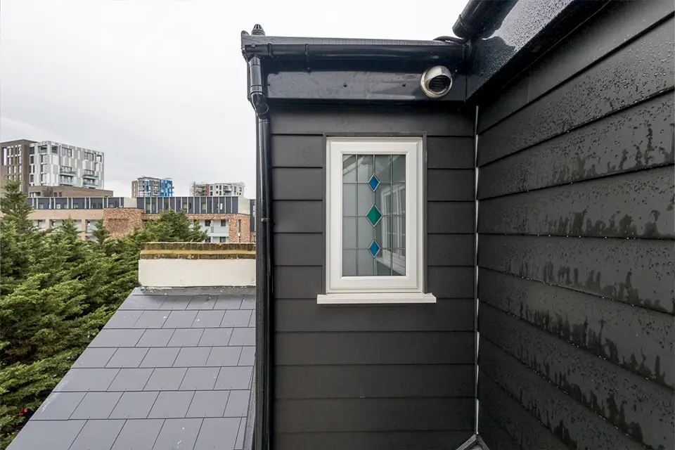 A newly built loft extension with black cladding.