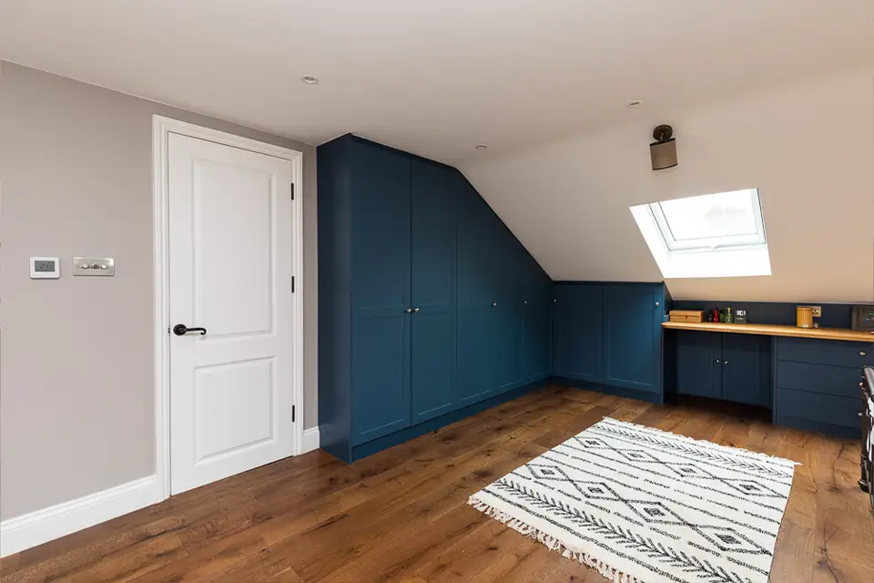 Blue painted built in wardrobes in a newly built loft conversion.