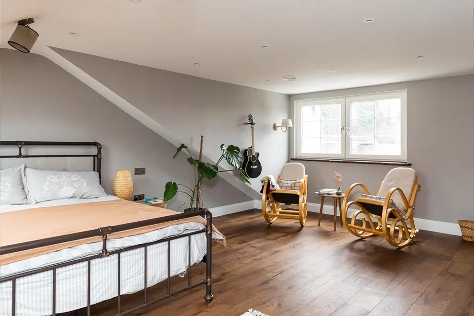 A large bedroom space in a loft conversion with a newly built dormer.
